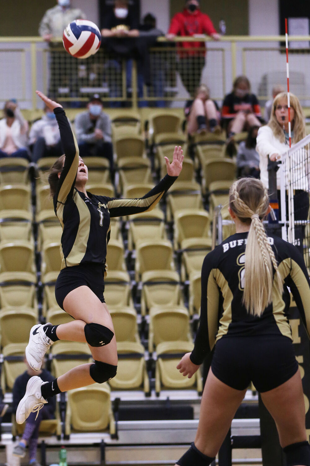 Tess Rule jumps for a lightly tapped hit over the net